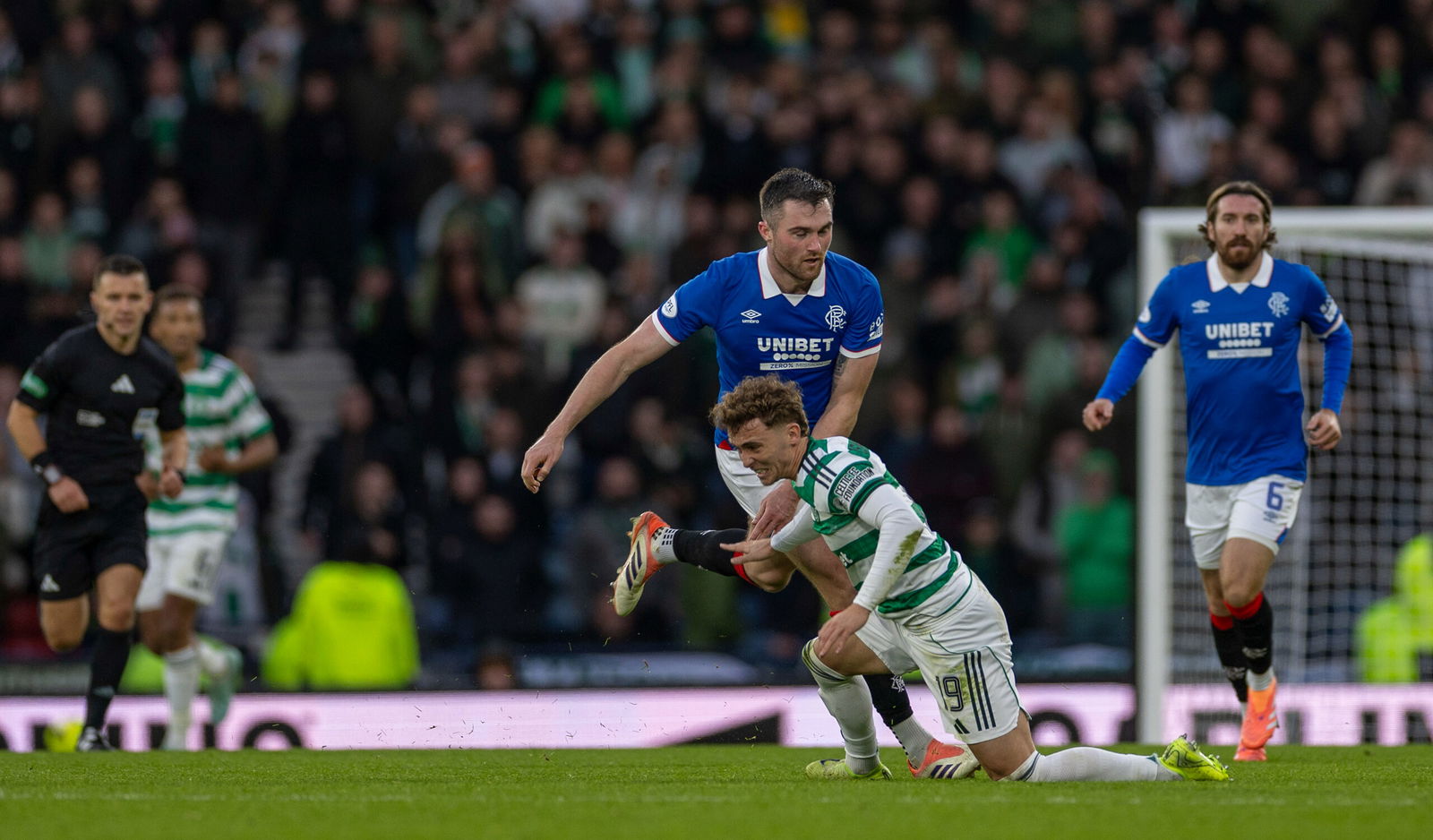 Celtic FC Callum Osmand tackled by Rangers FC Defender John Souttar